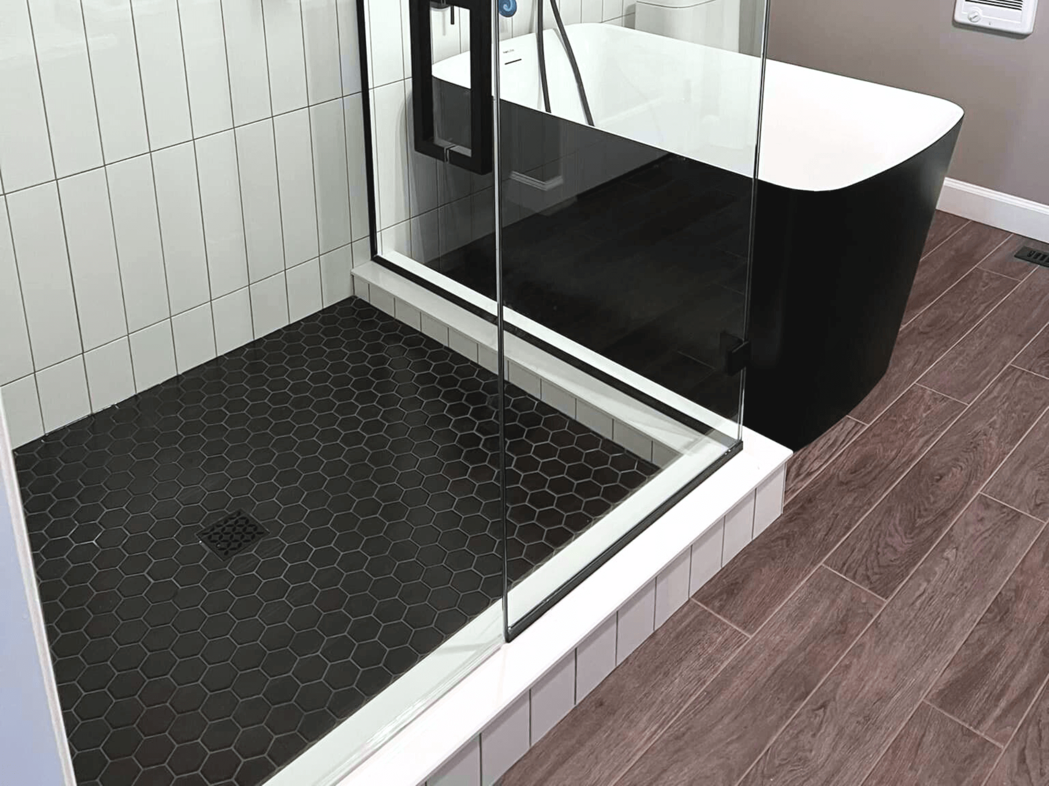 Tiled bathroom floor with tiled shower base.